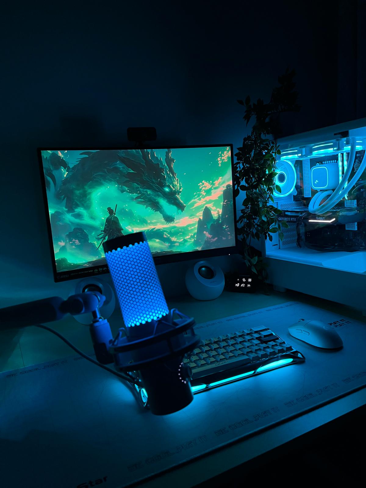 The desk this was built on: a white water-cooled PC with an RTX 4060, an MSI monitor, a condenser microphone and a mechanical keyboard, lit blue
