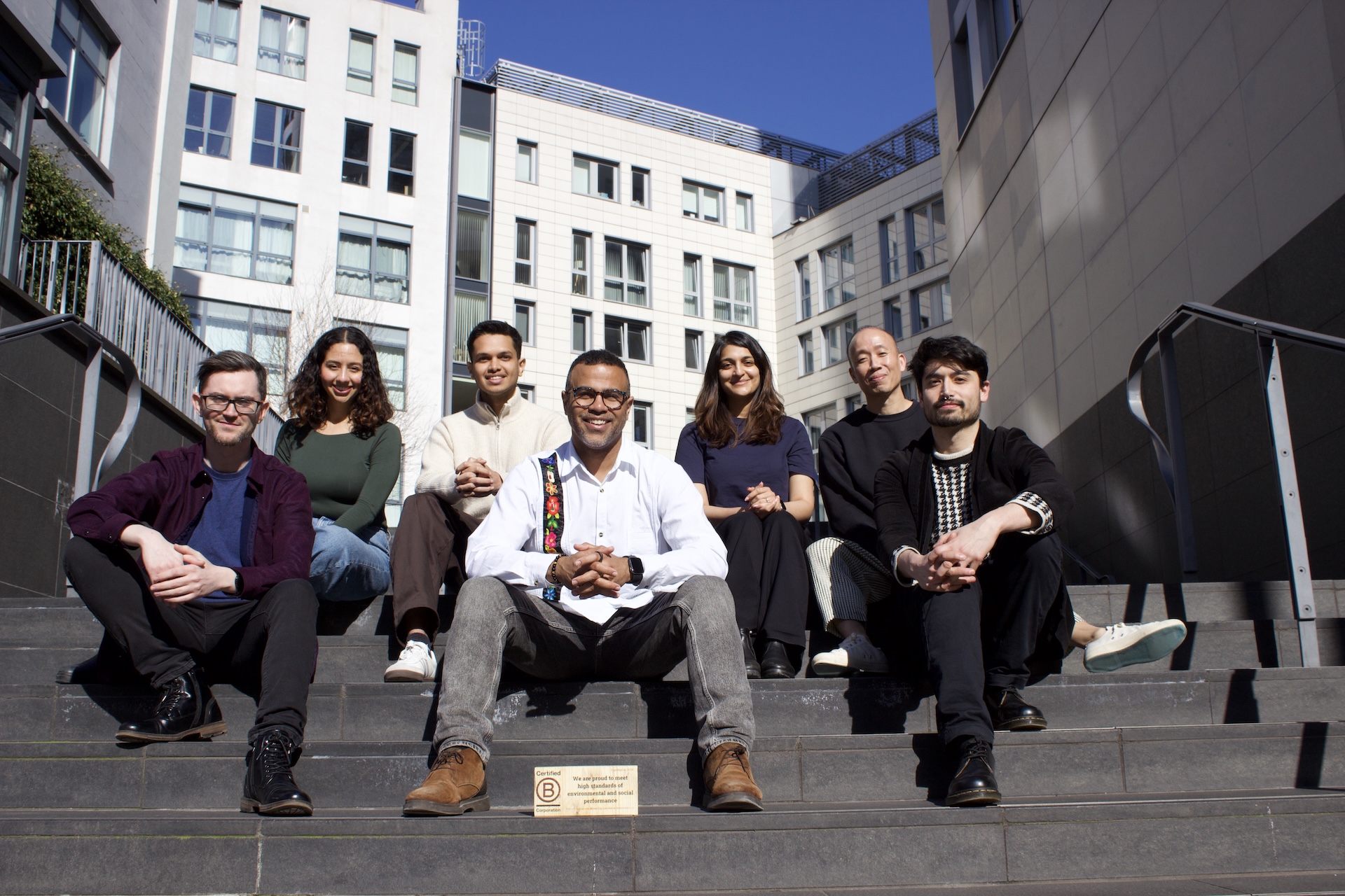 The Literal Humans team together on stone steps in London